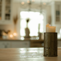 a photo of a candle in a beautiful farm style kitchen